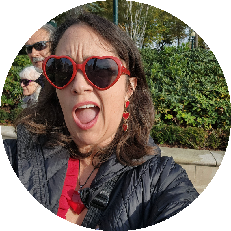 Amy, founder of The I'm Too Much Club, in heart-shaped red sunglasses